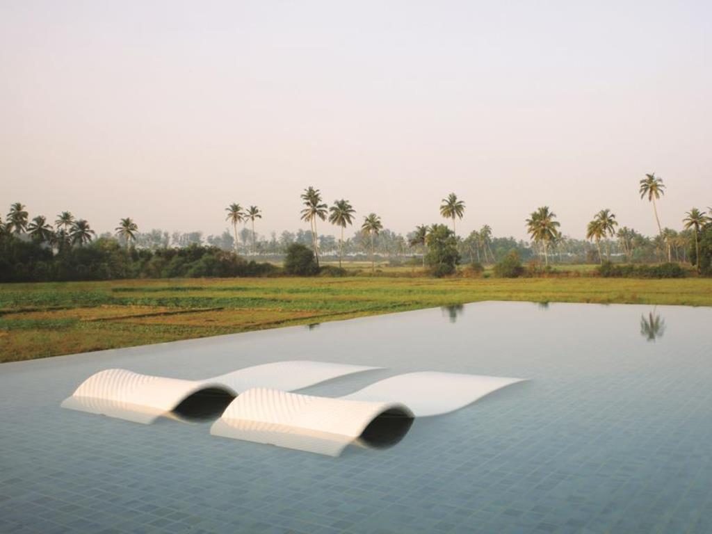 infinity pool and rice fields at alila diwa luxury hotel in goa