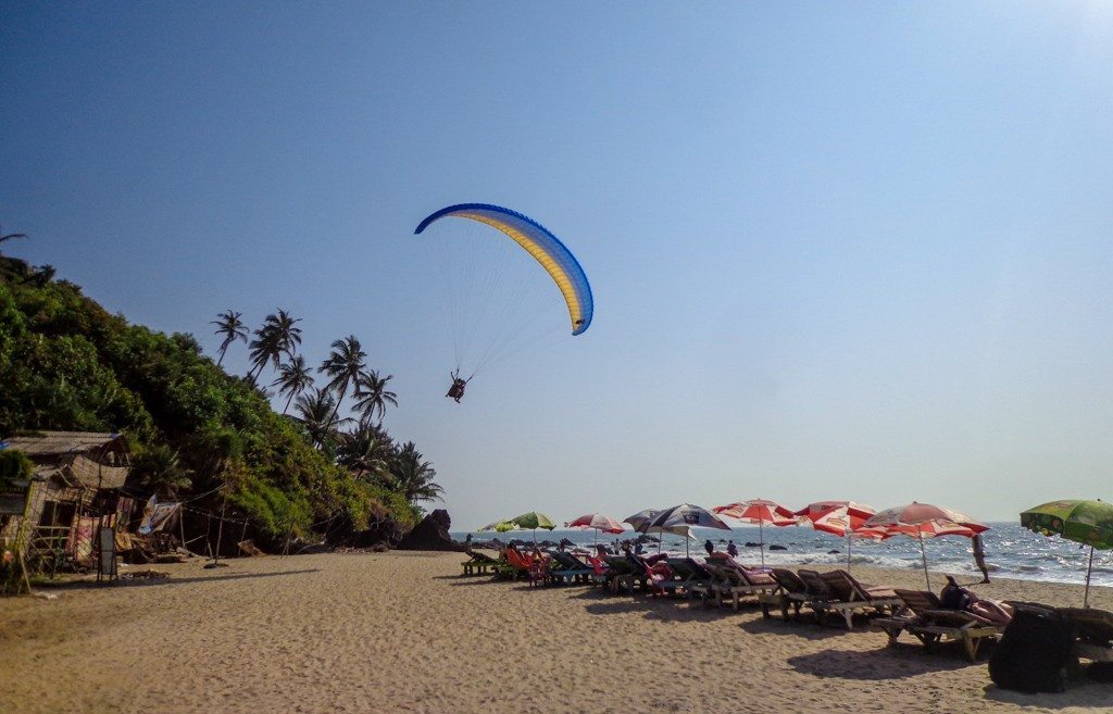 para gliding over the beach in goa