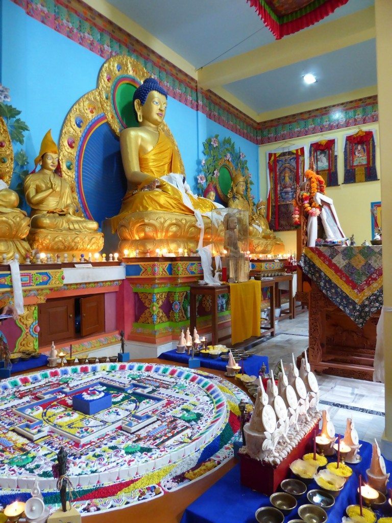 mandala and golden buddha inside Tibetan monastery 
