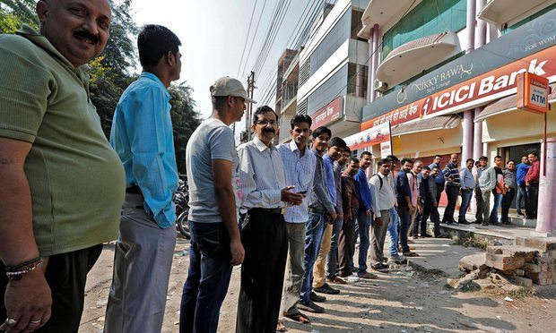 Queuing for money. Photo Credit: The Guardian 
