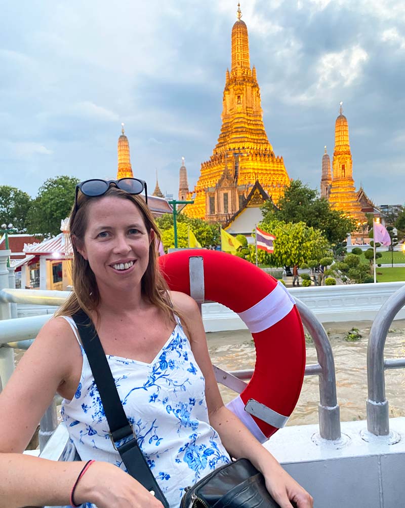 anna on a boat in bangkok by wat arun