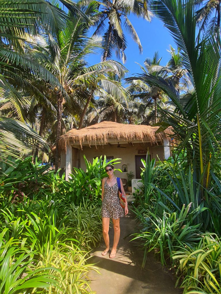 anna at a goa beach hut surrounded by palm trees